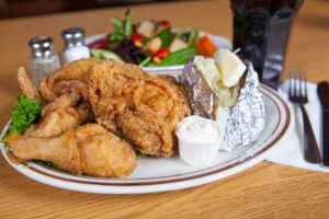 Fried chicken dinner with baked potato and sour cream from A Pine Restaurant in Pequot Lakes, MN