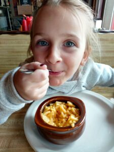 Kid eating some mac and cheese at A Pine restaurant in Pequot Lakes, MN