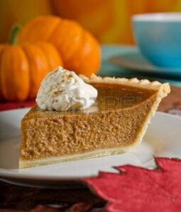 Slice of pumpkin pie with whipped cream